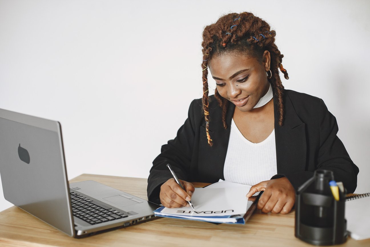 Woman in Black Cardigan Using Laptop Computer